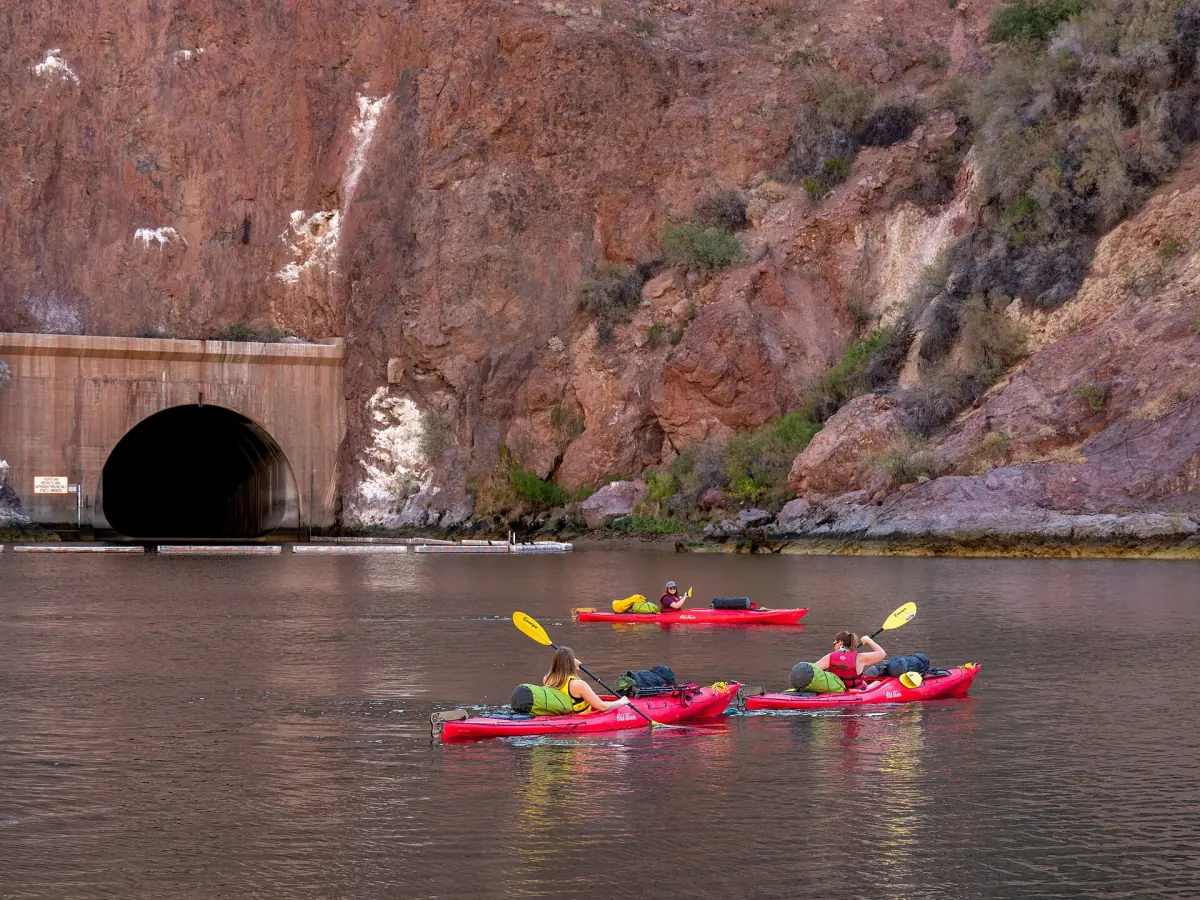 Kayakers paddling past a tunnel portal in the Black Canyon